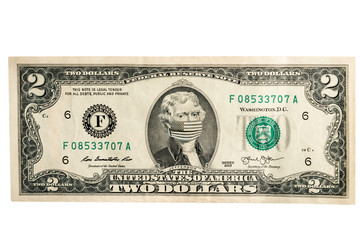 Two dollar concept with Thomas Jefferson masked by virus. Coronavirus protection. Horizontal frame