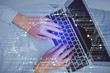 © peshkova - Double exposure of woman hands working on computer and data theme hologram drawing. Top View. Technology concept.