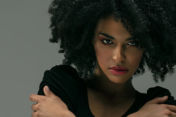 Wall Mural - Beautiful afro woman posing in studio.