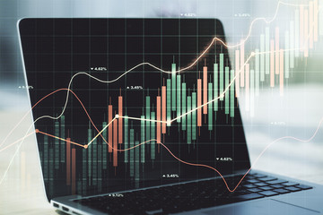 Double exposure of abstract creative financial chart on modern laptop background, research and strategy concept