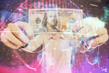 Fototapeta Mapy - Multi exposure of financial theme drawing hologram and USA dollars bills and man hands. Business concept.