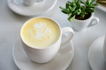 Cafe Latte table set with breakfast and green plant