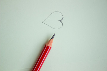 Fototapete - heart drawn in pencil on a paper sheet, close-up