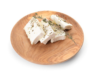 Plate with tasty feta cheese and spices on white background