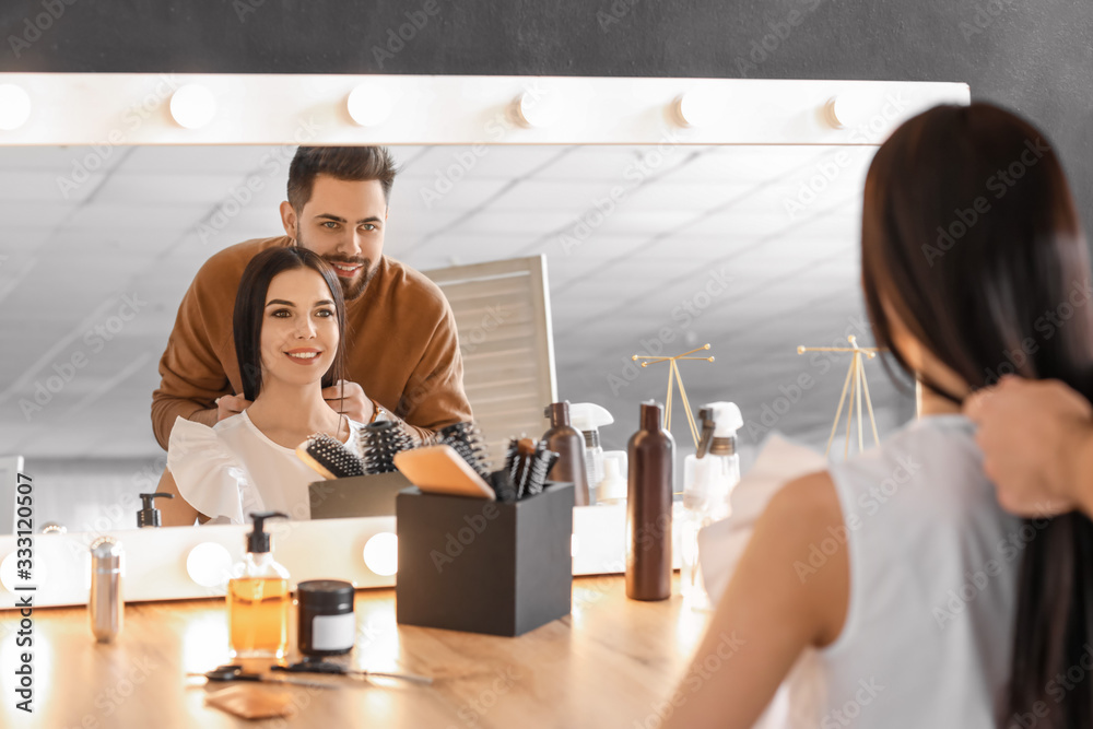 Hairdresser working with client in salon