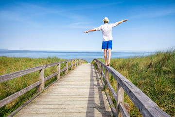 Wall Mural - young man enjoying life at the beach