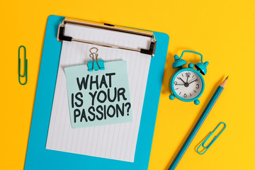 Conceptual hand writing showing What Is Your Passion Question. Concept meaning asking about his strong and barely controllable emotion Clipboard sheet note pencil clips alarm clock colored background