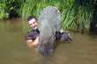 © sablin - Fisherman holding a giant catfish. Catch of fish, freshwater fishing, monster fish