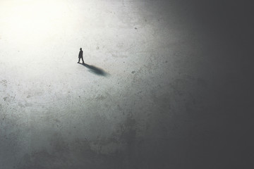 man walking in the night toward the light