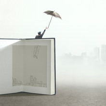 Man With Umbrella Flying Out Of A Illustrated Book; Surreal Concept