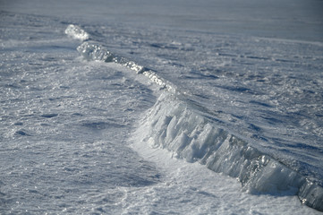 Wall Mural - the frozen surface of the lake on a sunny winter day.