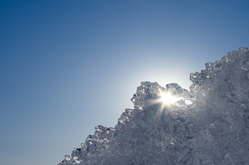 Wall Mural - a frozen ice floe shines in the sun on a winter day against the sky