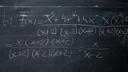 Wall Mural - maths formulas written by white chalk on the blackboard background.