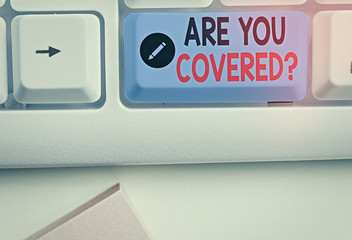 Writing note showing Are You Covered Question. Business concept for asking showing if they had insurance in work or life