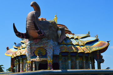 Wall Mural - Buddha image standing on an elephant-shape church