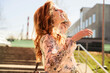 © Вячеслав Чичаев - Portrait of a happy stylish beautiful woman with long hair on the background of the steps of the building in spring in the sun in bright weather.