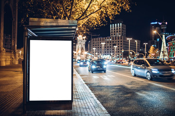 night shot of a luminous advertising lightbox or display at a bus stop in barcelona, spain