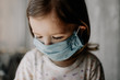 © Ananass - a young child wearing a protective medical mask is home treated at home
