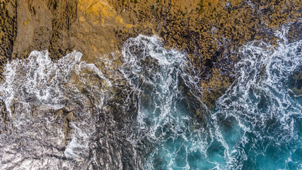 Canvas Print - Waves of turquoise water washed by the rocky stone coast of Portugal. Aerial view.