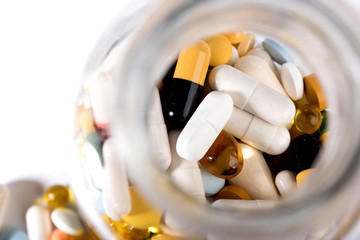 Pills spilled out of pill bottle, top view. Medication and medicine tablets