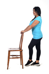 Wall Mural - woman playing with a chair in white background, profile