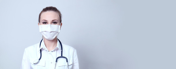 Female doctor in a protective medical mask. Pandemic virus COVID-19