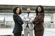 © Mangostar - Happy confident business team posing in hallway. Business man and women standing with arms folded, looking at camera, smiling. Teamwork and success concept