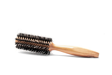 Round hairbrush with wooden handle isolated on white background.