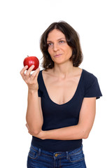 Wall Mural - Studio shot of beautiful woman holding apple isolated against white background