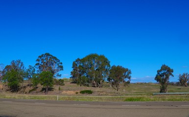 freeway in australian country town midway between sydney and melbourne with nice blue sky and lush g