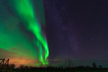 beautiful aurora borealis in northern norway with the milky way next to it