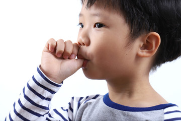 little boy sucking thumb isolated on white background