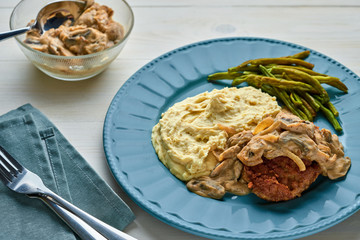 Sticker - Meat Burger with Mushroom Gravy, Smashed Potatoes and Green Beans on Wooden table. Top view, directly above.