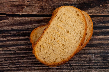 Fresh wheat toast on a wooden background. Close up.