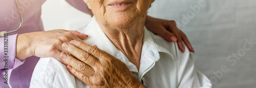 Fotomural Elderly female hand holding hand of young caregiver at nursing home