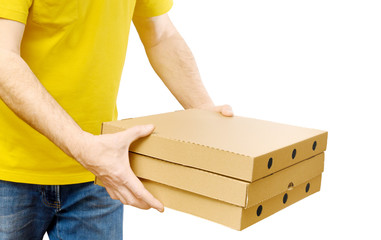 Delivery man in yellow shirt is carrying boxes of pizza isolated on white. Fast Food delivery service.