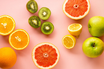 Wall Mural - Fruits rich in vitamin C on a pink background