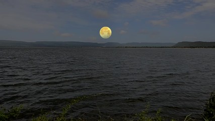 Wall Mural - Full moon rise over the lake in ealy evening