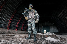Military Man In Gas Mask In Hangar