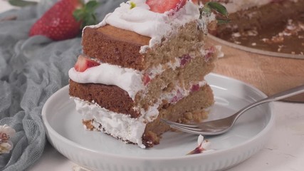 Wall Mural - Strawberry cake, strawberry sponge cake with fresh strawberries and sour cream on a kitchen countertop.