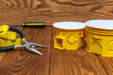 Kit yellow spare parts for electrical and a tools prepared on vintage wooden boards before repair or setting