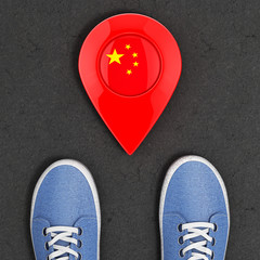 Poster - Travel to China Concept. Blue Denim Sneakers on the Asphalt Road with Map Pointer and China Flag Top View. 3d Rendering