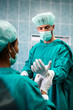 © NDABCREATIVITY - Team of surgeons in the operating room preparing for surgery