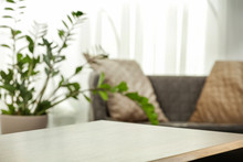 Spring Time And Wooden Desk In Home Interior With Blurred Window. 