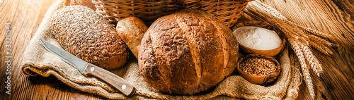 Cuadros en Lienzo Various bread with wheat on old table