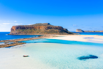 Amazing view of Balos Lagoon with magical turquoise waters, lagoons, tropical beaches of pure white sand and Gramvousa island on Crete, Greece