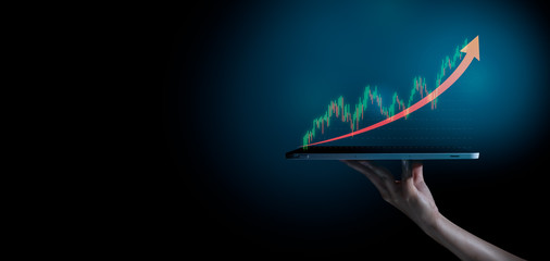 Business evolution to success and growing growth concept.hand holding an empty digital tablet with growth stock graph and rising arrow,Corporate representing business growth.