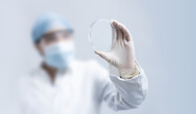 Blurry Female Scientist Holding Empty Petri Dish