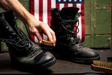 Man Polishing Vintage Military Boots