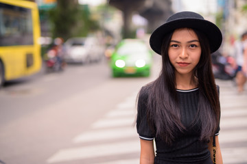 Young beautiful Asian tourist woman in the city streets